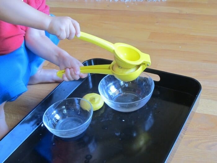 A child squeezing a lemon