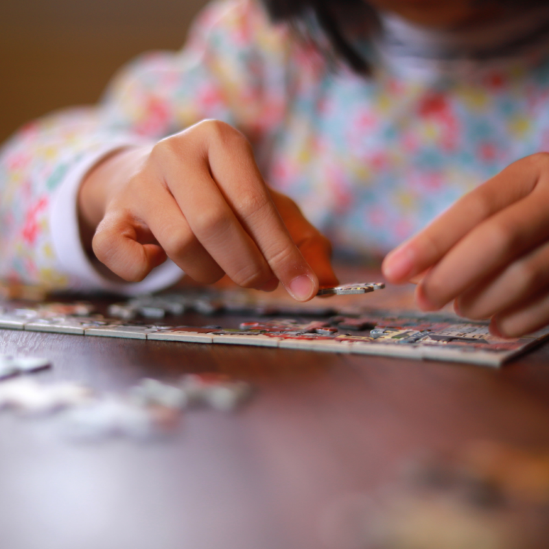 a child putting together a picture puzzle (1)