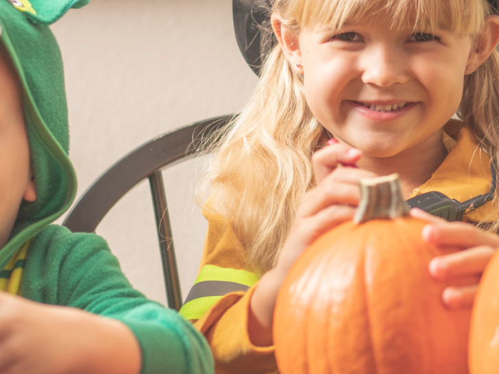 kids carving pumpkins on halloween