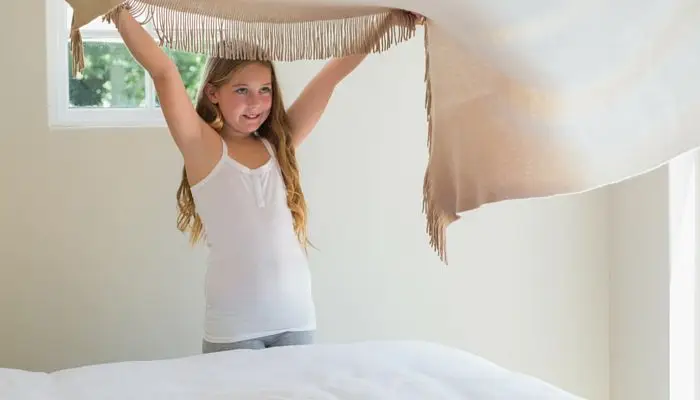 A girl making a bed