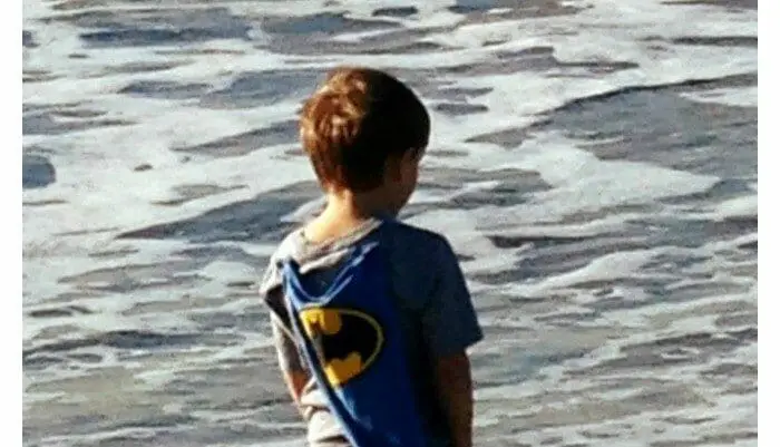 a child walking in the ocean shore
