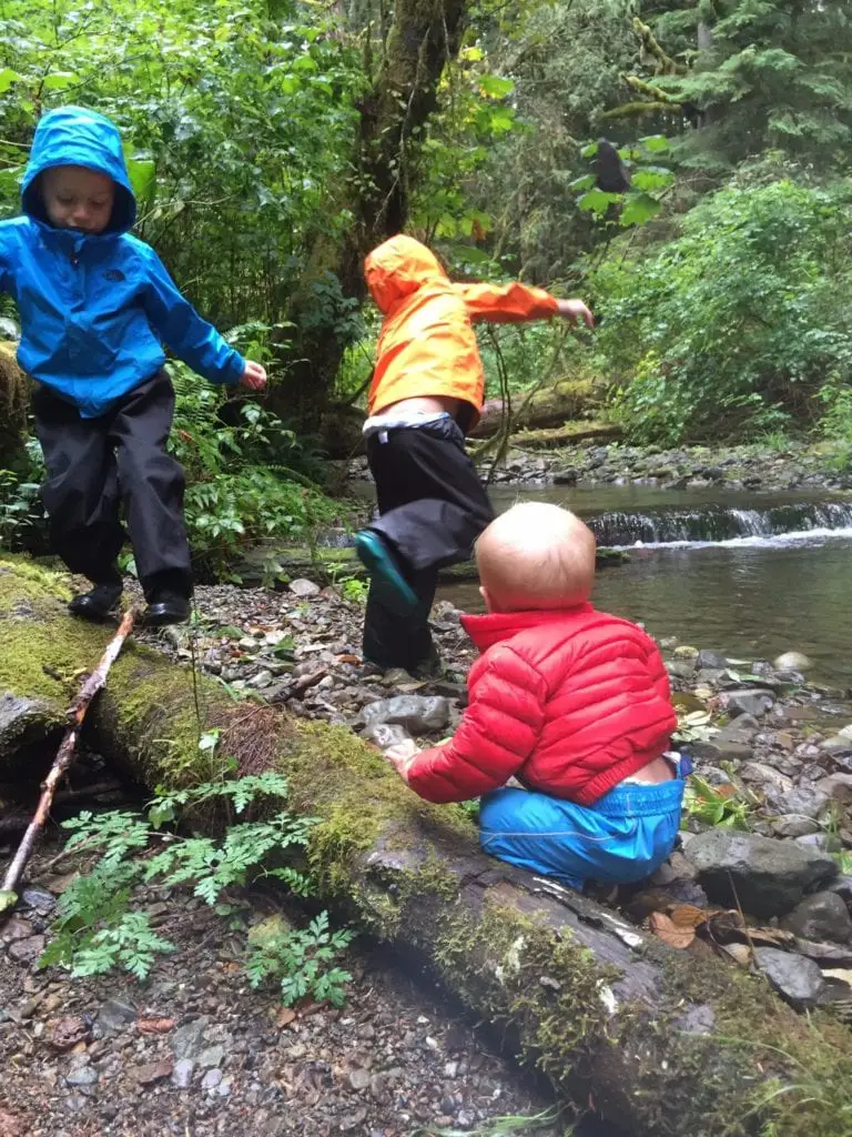 Boys playing by a creek