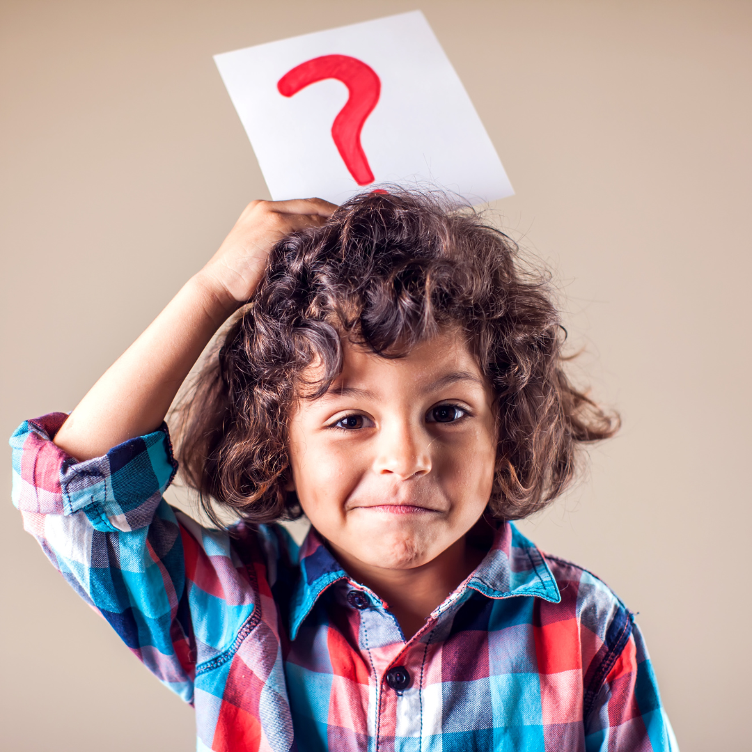 a child holding a question mark over his head