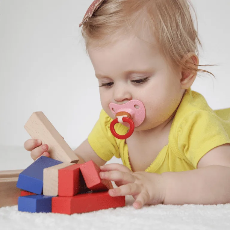 A baby playing with blocks