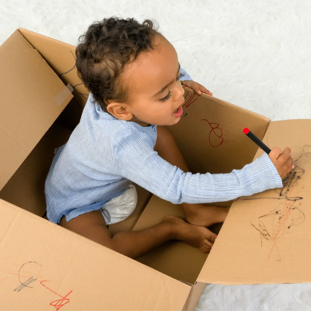 Toddler in a Cardboard Box