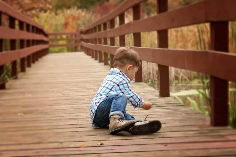 Boy Sitting on Wooden Dock