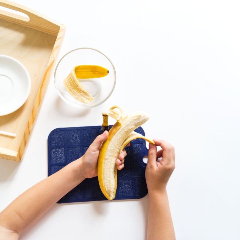 A child peeling a banana