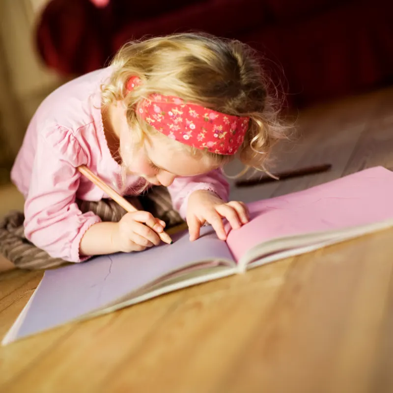 A young girl writing