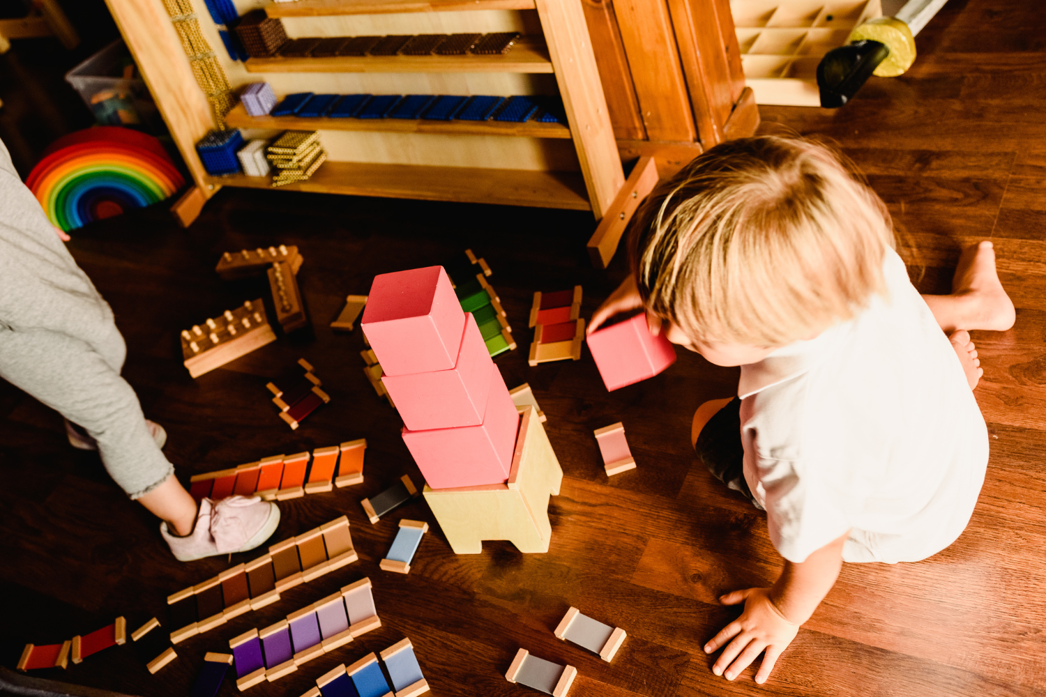 a toddler working with Montessori materials